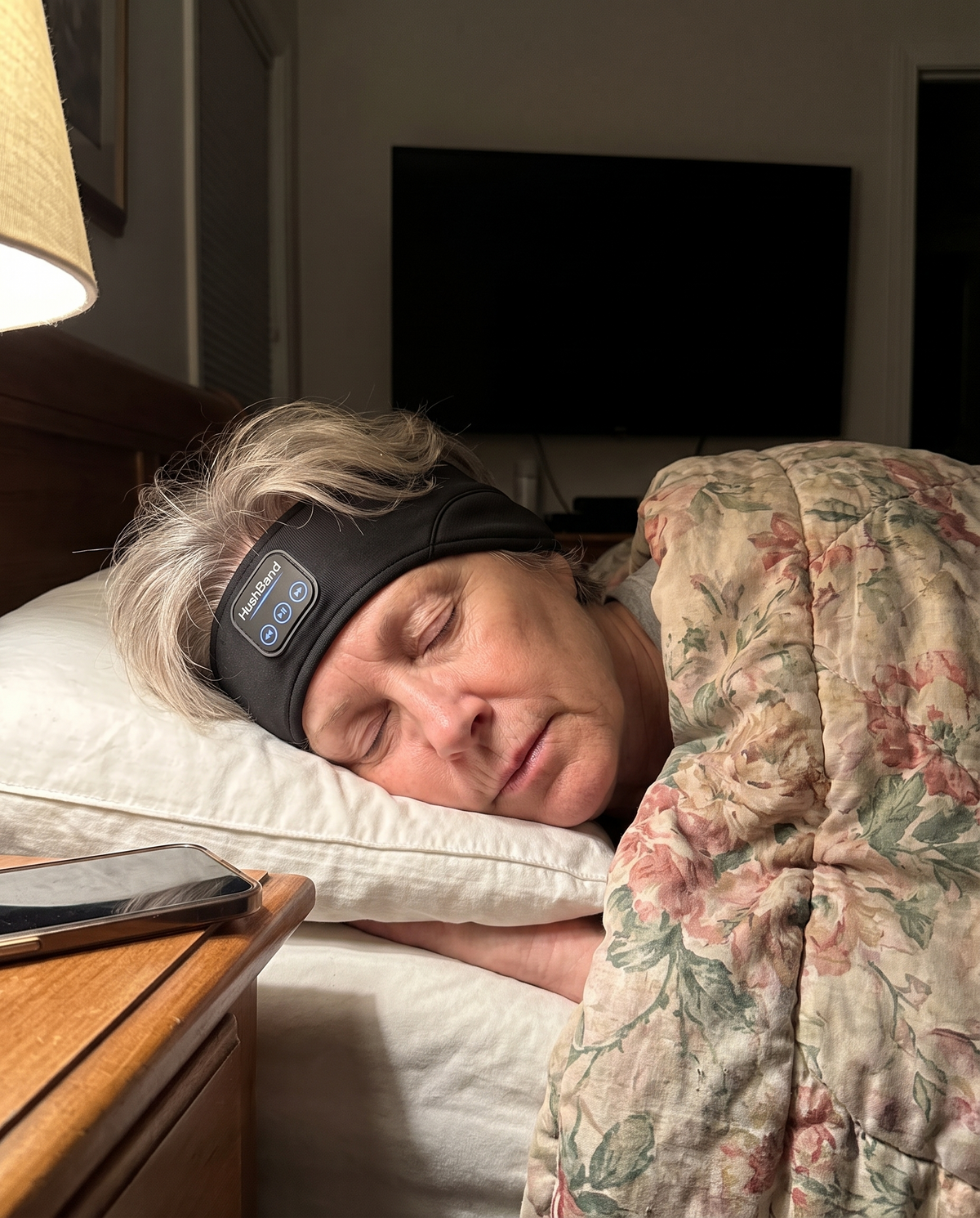 A woman in her 60s asleep on her side wearing HushBand